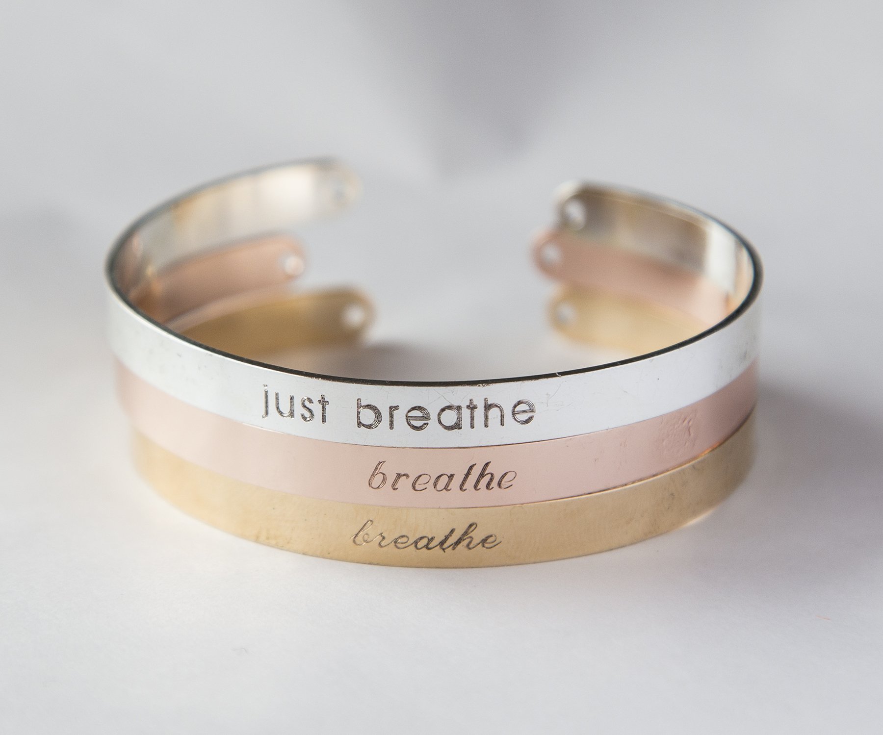 Just Breathe Bracelet made of copper with gold, rose gold, or silver plating, featuring an adjustable design and engraved mantra.