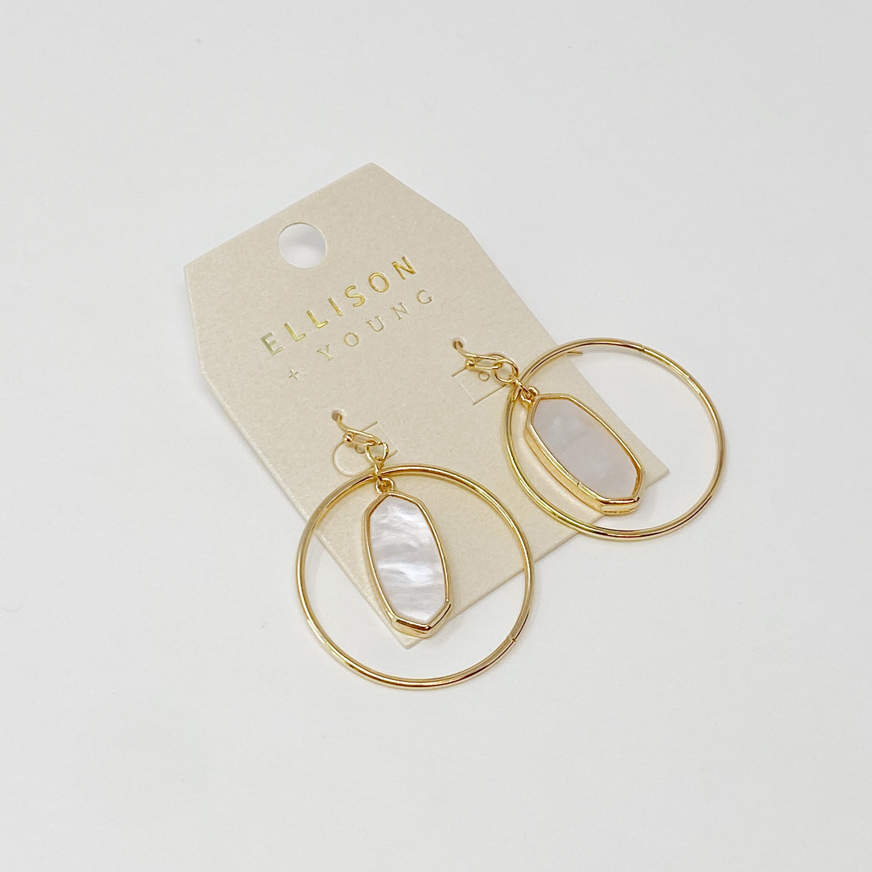 Kenzie Circle Drop Earrings featuring a dangling hoop design with a beautiful center piece, crafted from alloy metal.