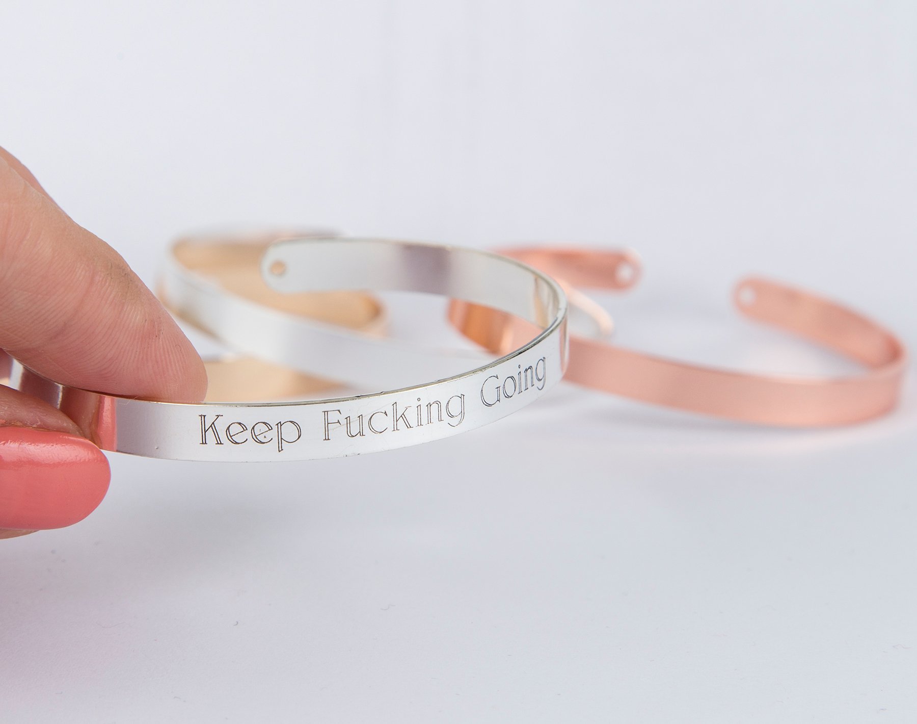 Keep Fucking Going Bracelet in gold, rose gold, and silver plating, adjustable design with motivational engraving.