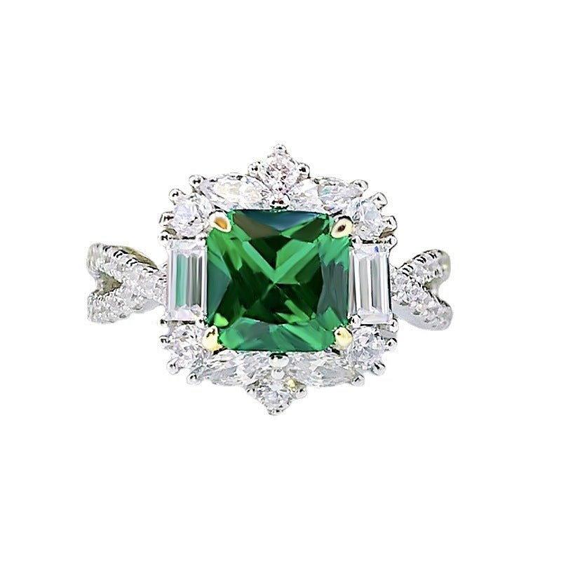 A stunning lab emerald baguette sterling silver ring featuring a vibrant green center stone surrounded by sparkling white sapphires.