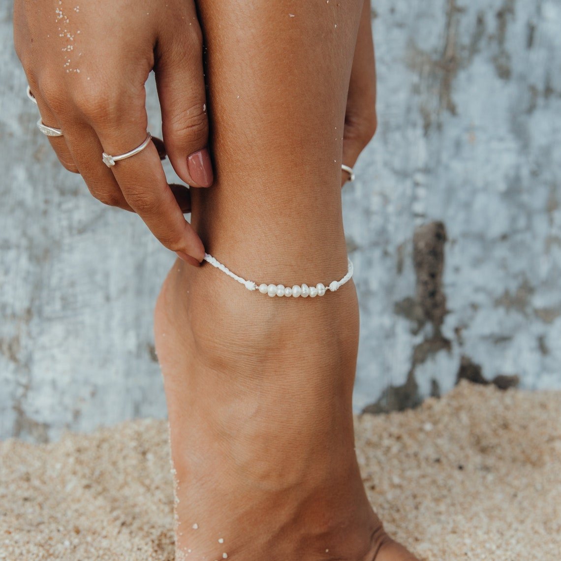 Lahaina Pearl Handmade Anklet featuring white wax cord and freshwater pearls, elegantly displayed on a soft surface.