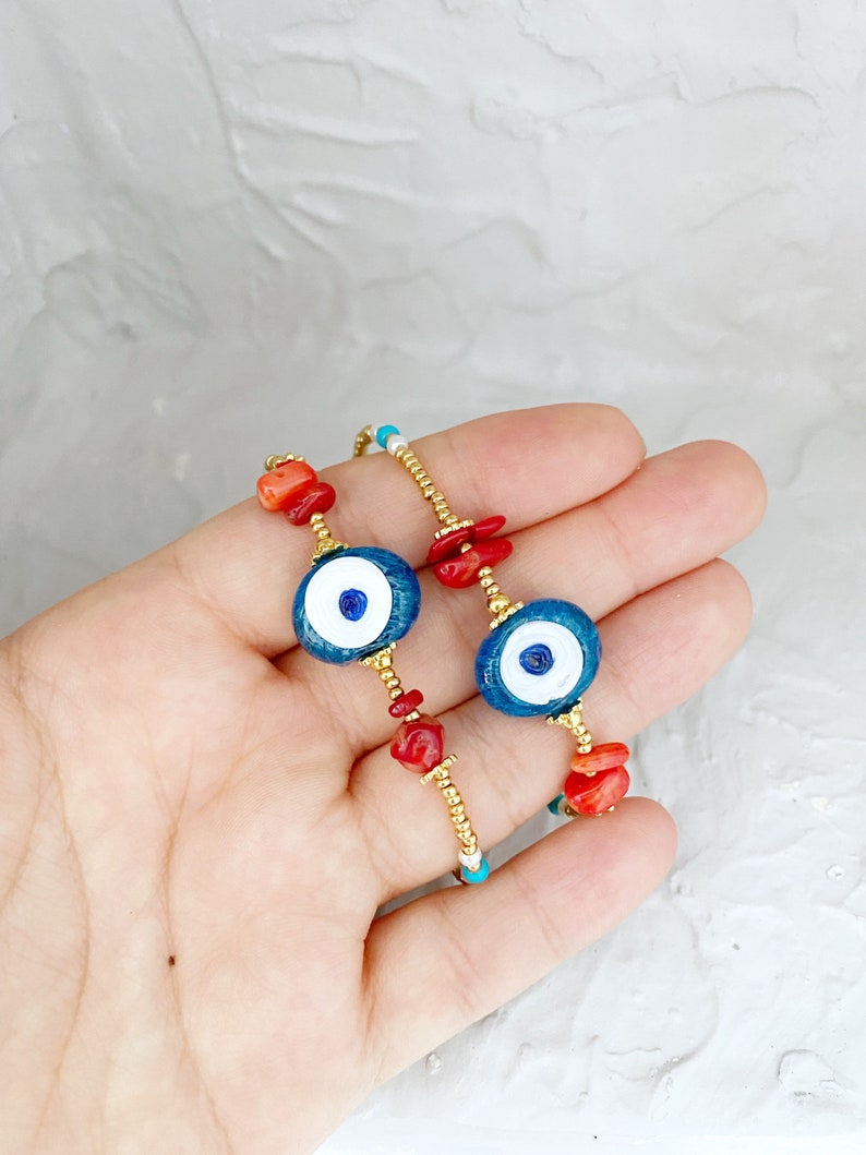Large Evil Eye Bracelet featuring handmade glass beads, baroque beads, and vibrant seed beads in blue and turquoise colors.