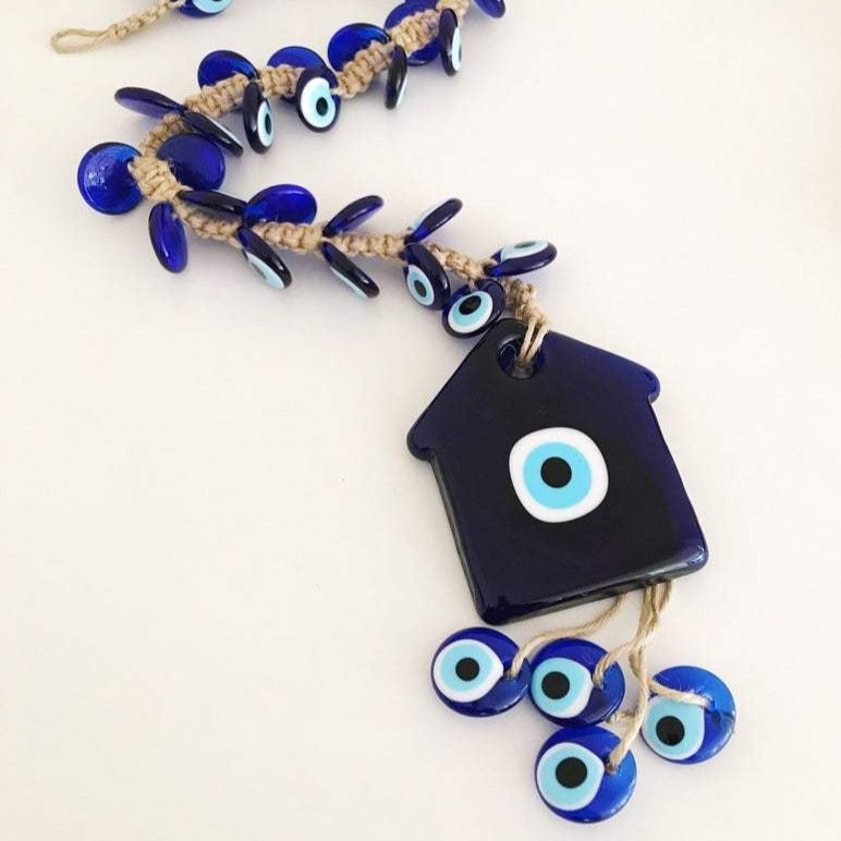 Large evil eye wall hanging with 41 beads, featuring a big evil eye bead and 40 smaller beads, handmade and unique.