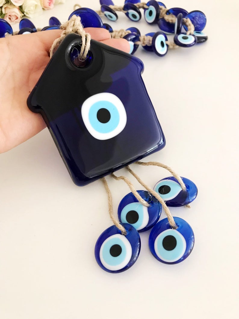 Large evil eye wall hanging with 41 beads, featuring a big evil eye bead and 40 smaller beads, handmade and unique.