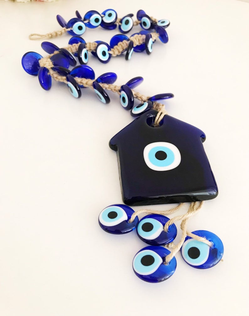 Large evil eye wall hanging with 41 beads, featuring a big evil eye bead and 40 smaller beads, handmade and unique.