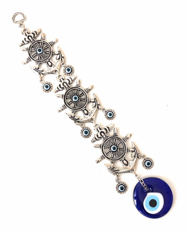 Large Evil Eye Wall Hanging featuring blue evil eye bead, hamsa hand, and lucky elephant designs, crafted from metal for home decor.