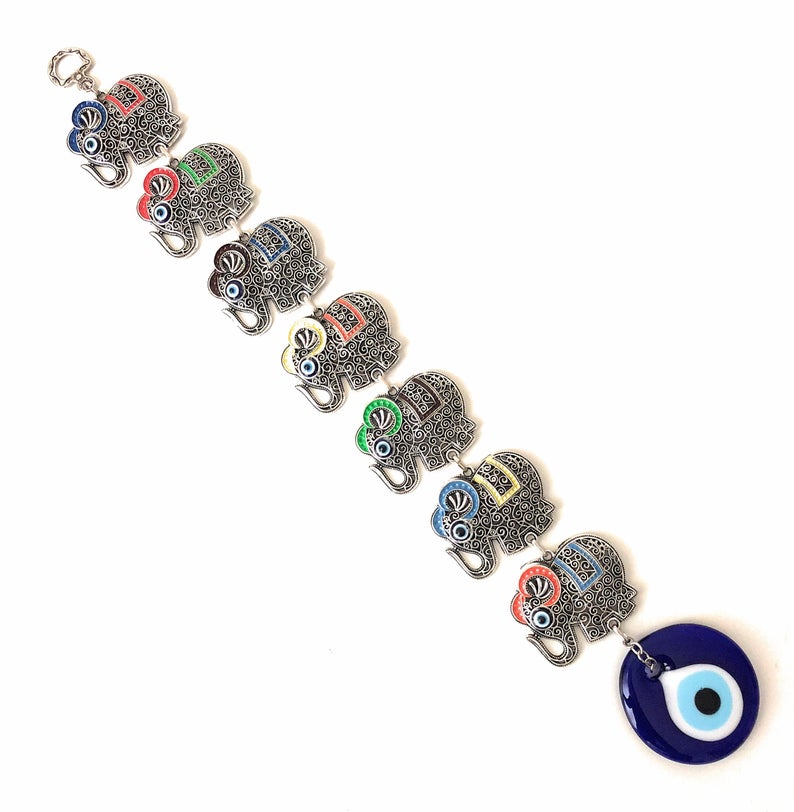Large Evil Eye Wall Hanging featuring blue evil eye bead, hamsa hand, and lucky elephant designs, crafted from metal for home decor.