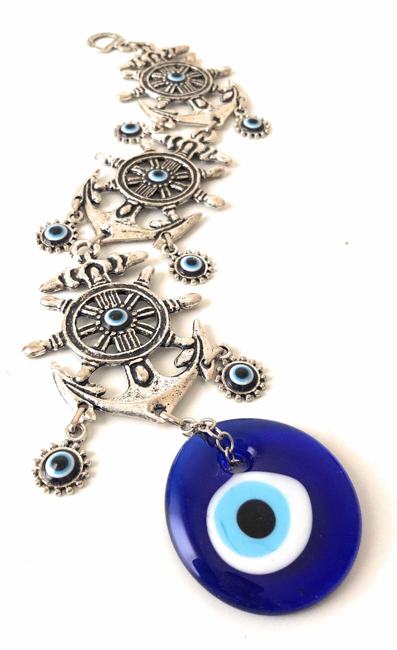 Large Evil Eye Wall Hanging featuring blue evil eye bead, hamsa hand, and lucky elephant designs, crafted from metal for home decor.