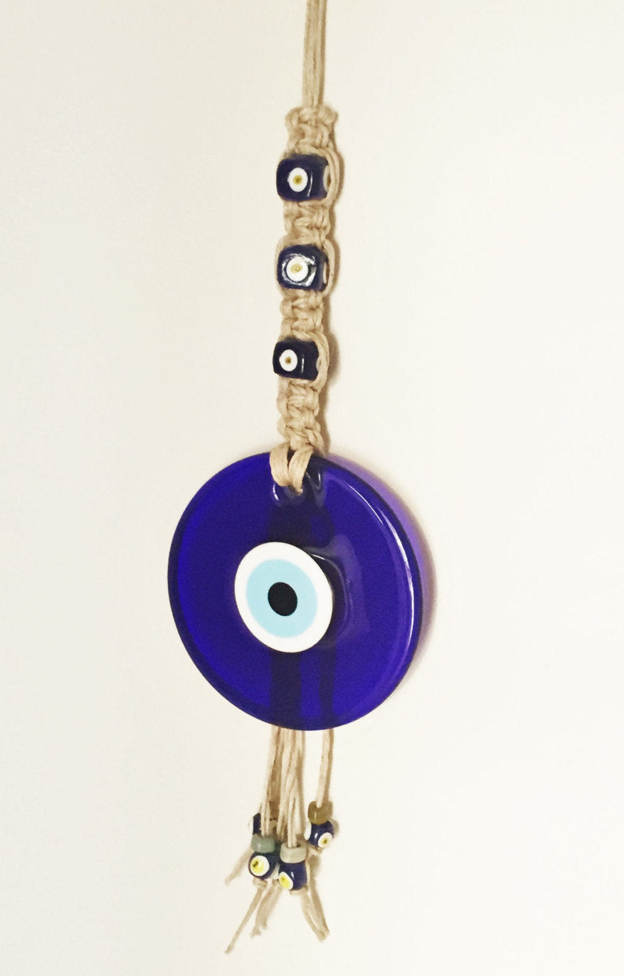 Large Macrame Evil Eye Wall Hanging featuring a central 18cm evil eye surrounded by smaller glass evil eyes, intricately designed with macrame.