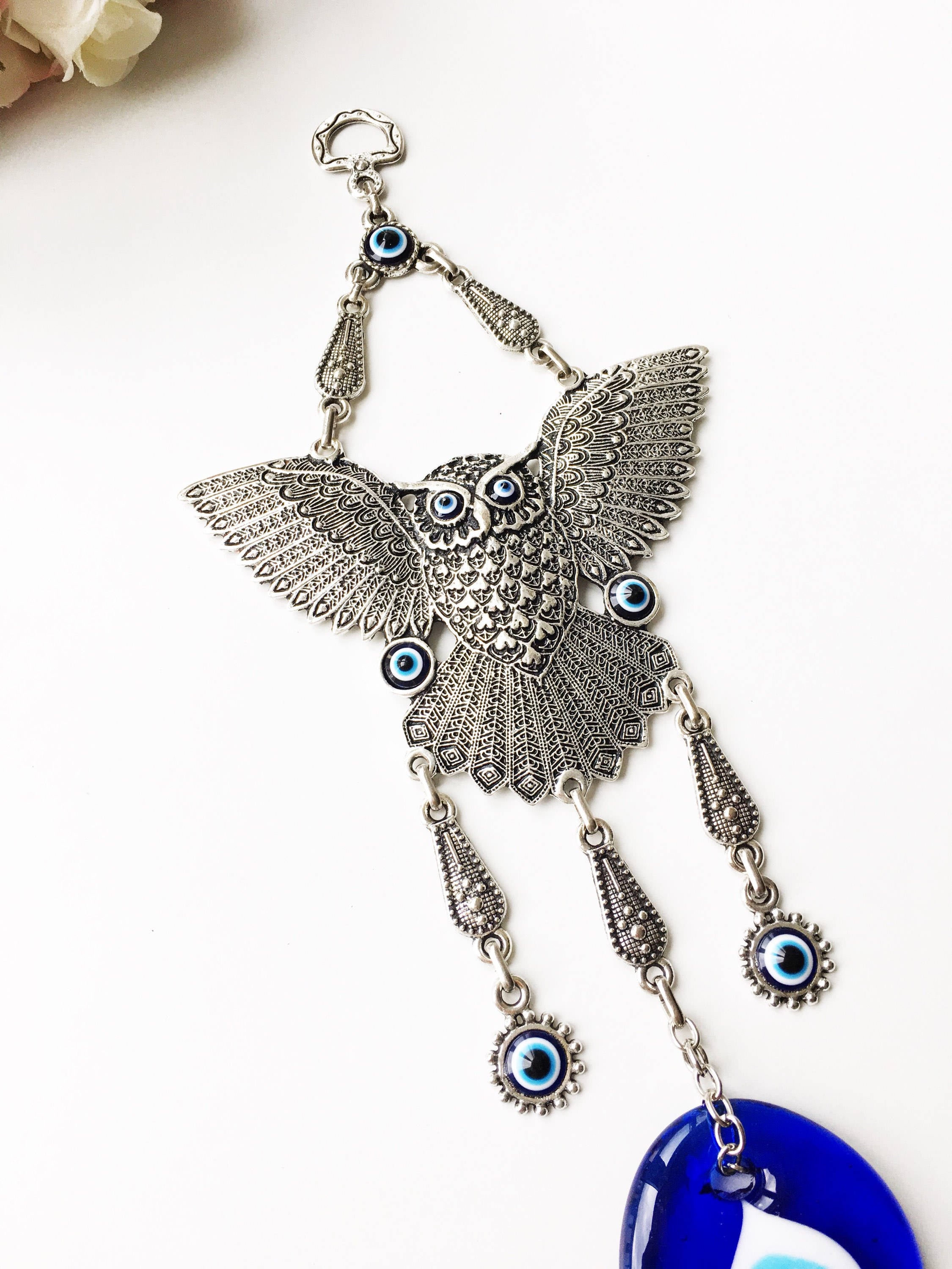 A beautifully handcrafted Large Owl Evil Eye Wall Hanging featuring a vibrant glass evil eye bead and intricate metal charm details.