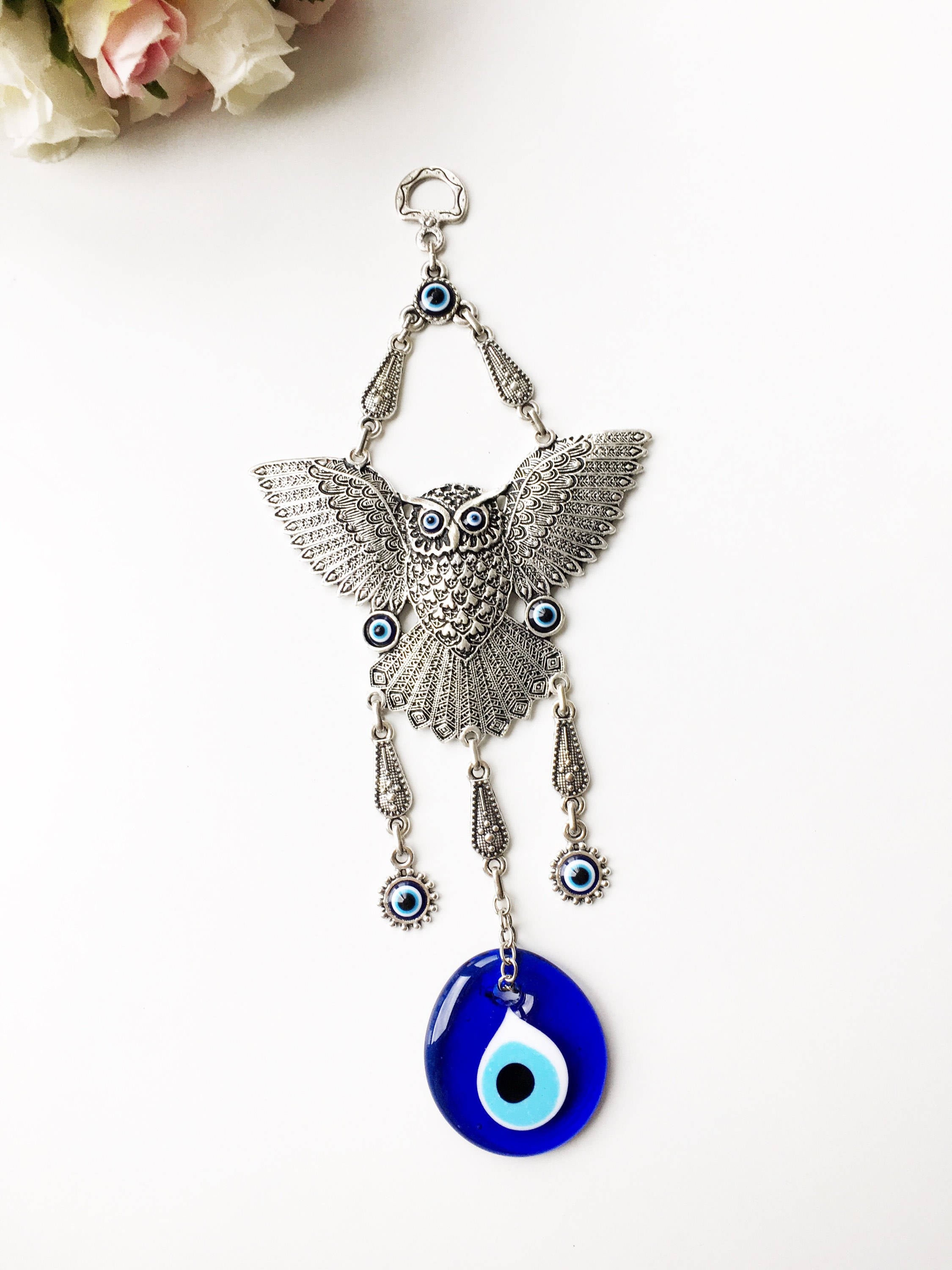 A beautifully handcrafted Large Owl Evil Eye Wall Hanging featuring a vibrant glass evil eye bead and intricate metal charm details.