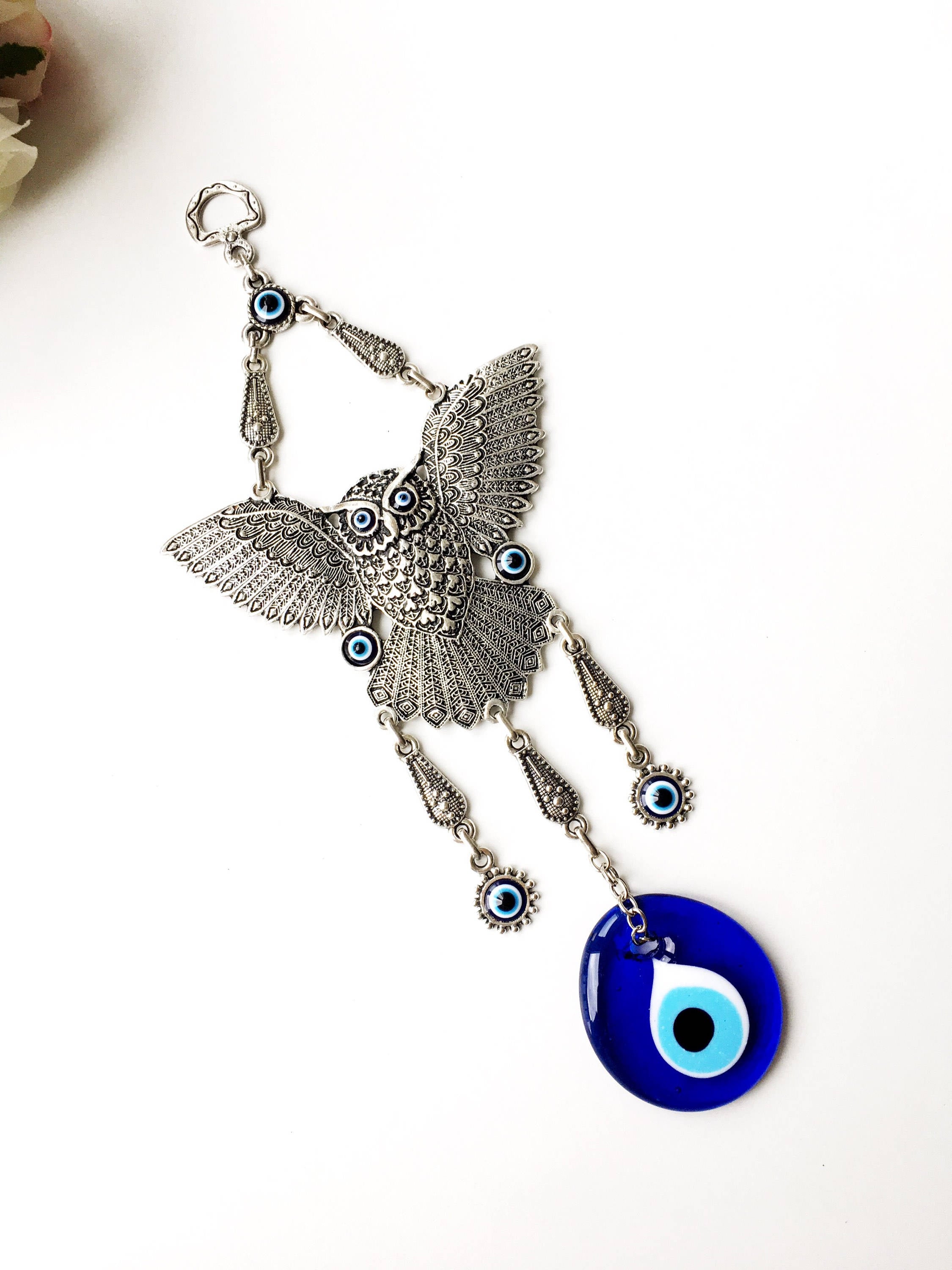A beautifully handcrafted Large Owl Evil Eye Wall Hanging featuring a vibrant glass evil eye bead and intricate metal charm details.