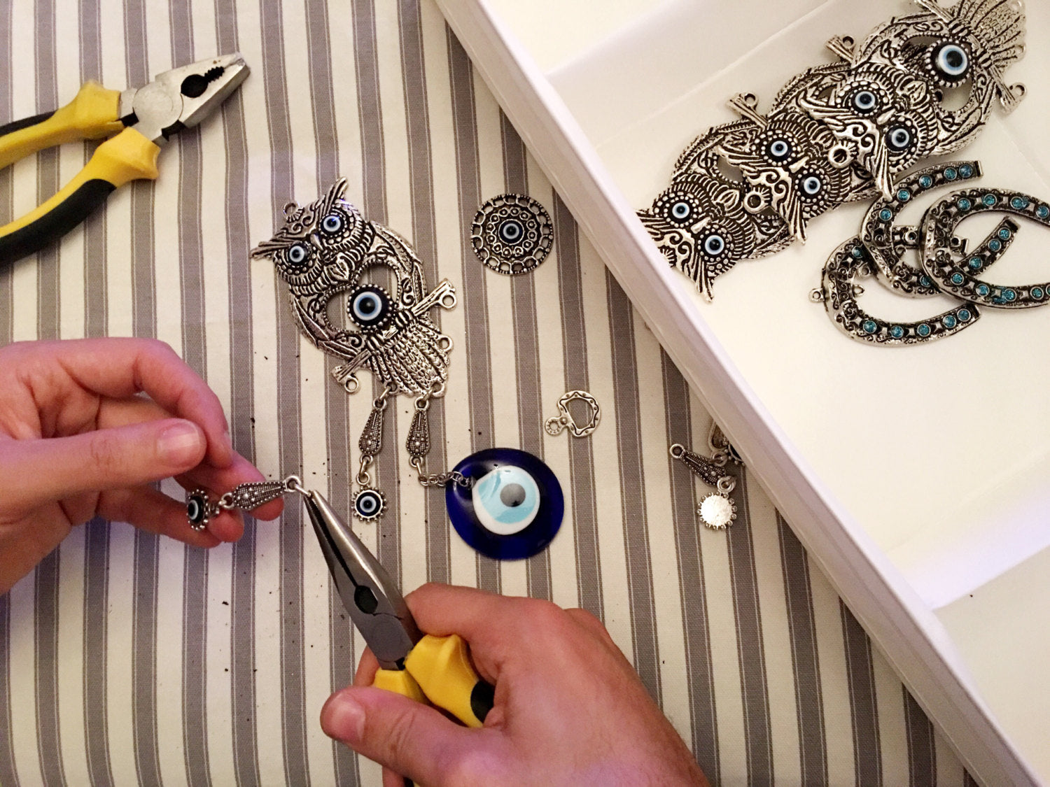 A beautifully handcrafted Large Owl Evil Eye Wall Hanging featuring a vibrant glass evil eye bead and intricate metal charm details.