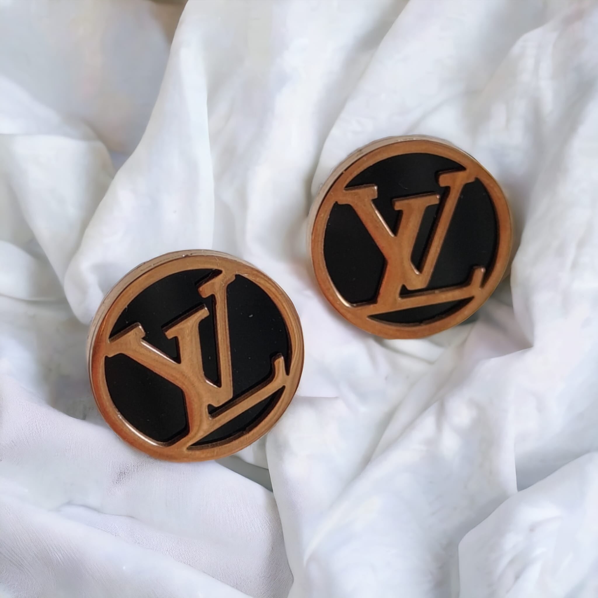 Large round black elegant rose gold plated stud earrings showcasing a contemporary design with a luxurious finish.