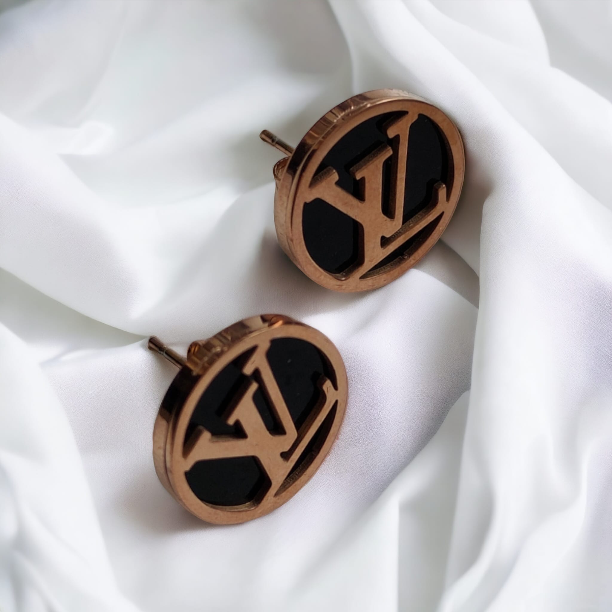 Large round black elegant rose gold plated stud earrings showcasing a contemporary design with a luxurious finish.