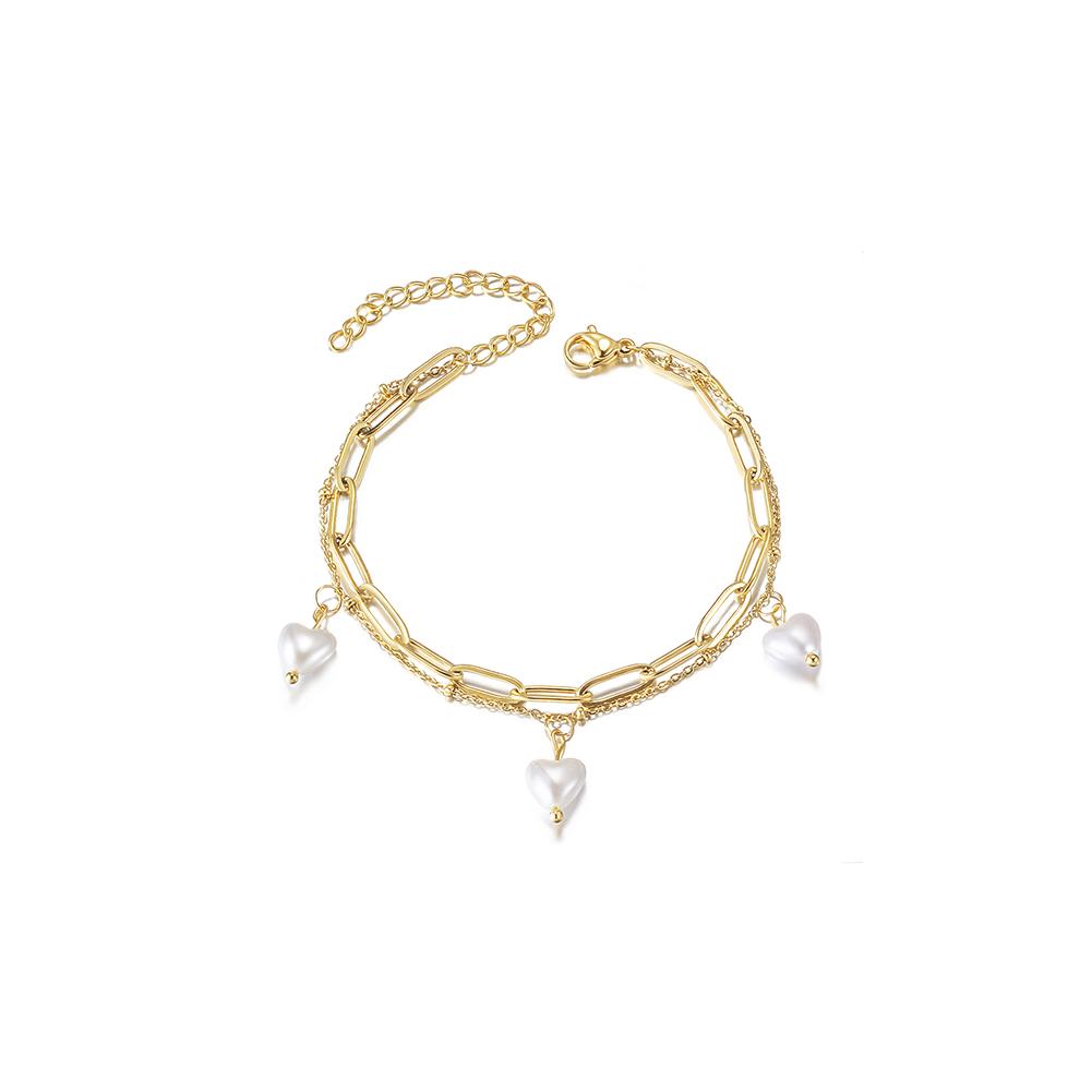 Layered heart-shaped pearl bracelet made of surgical stainless steel with 14K gold PVD plating, showcasing elegance and durability.