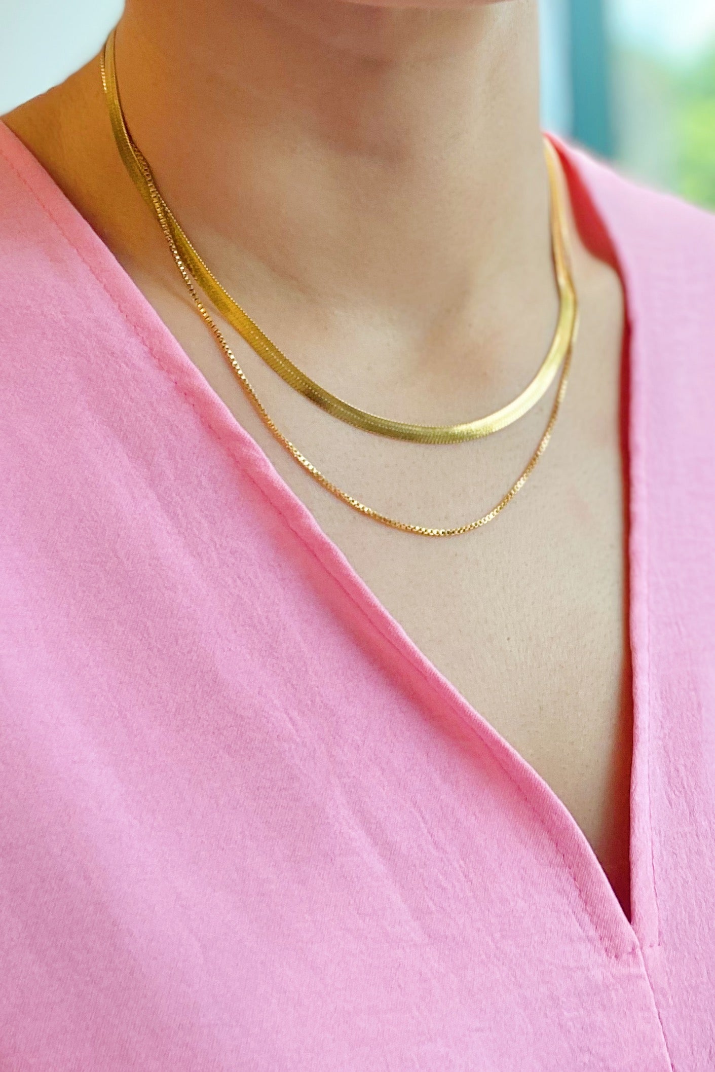 Layered Herringbone Chain Necklace featuring a 16-inch herringbone chain and an 18-inch slim chain, both in 18k gold plated stainless steel.