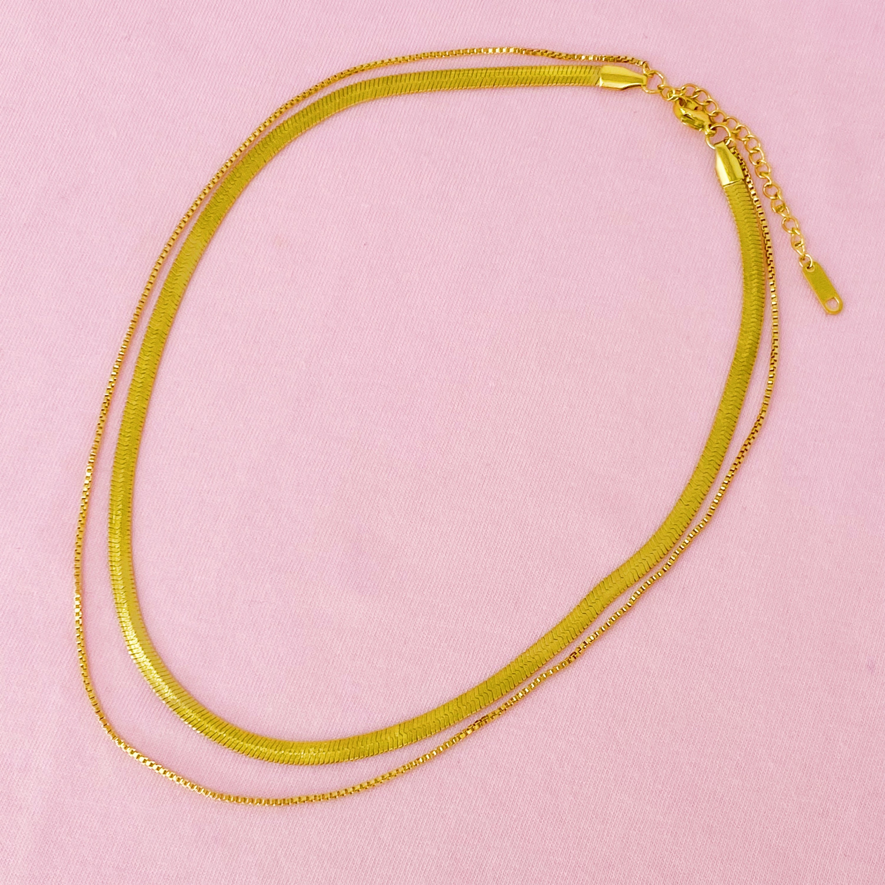 Layered Herringbone Chain Necklace featuring a 16-inch herringbone chain and an 18-inch slim chain, both in 18k gold plated stainless steel.