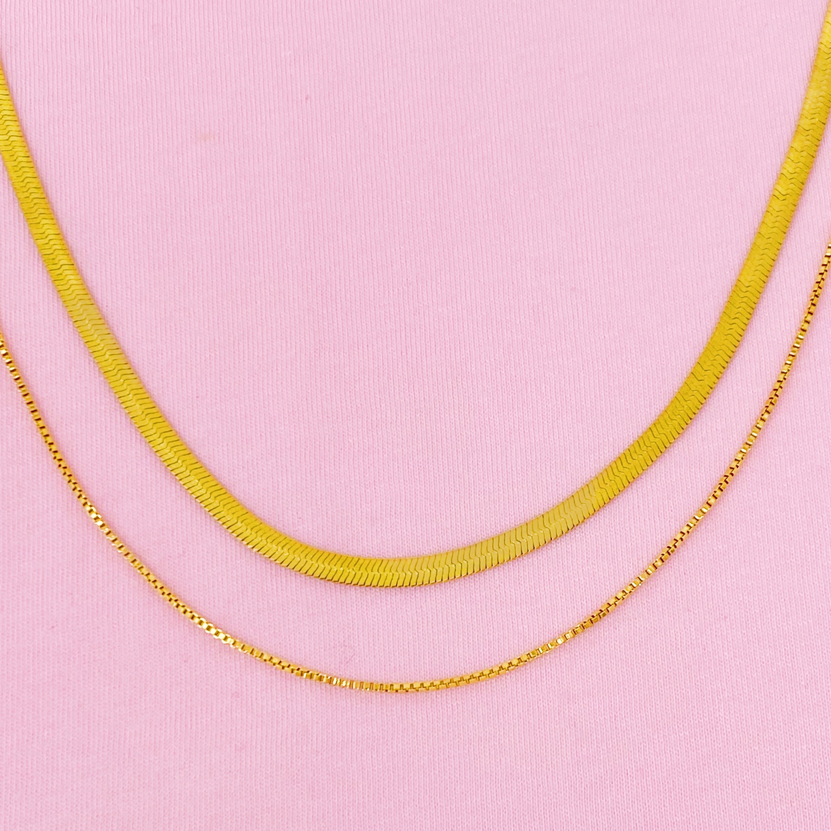 Layered Herringbone Chain Necklace featuring a 16-inch herringbone chain and an 18-inch slim chain, both in 18k gold plated stainless steel.