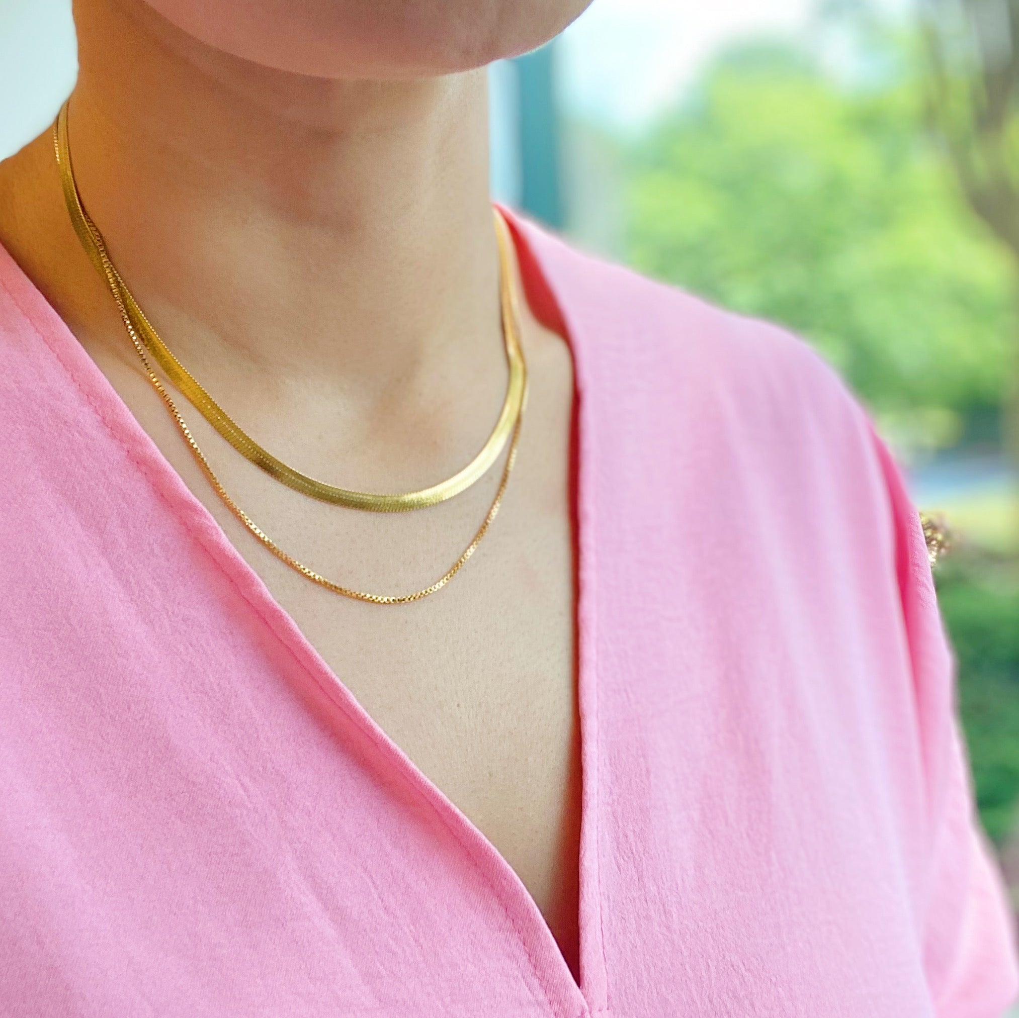 Layered Herringbone Chain Necklace featuring a 16-inch herringbone chain and an 18-inch slim chain, both in 18k gold plated stainless steel.