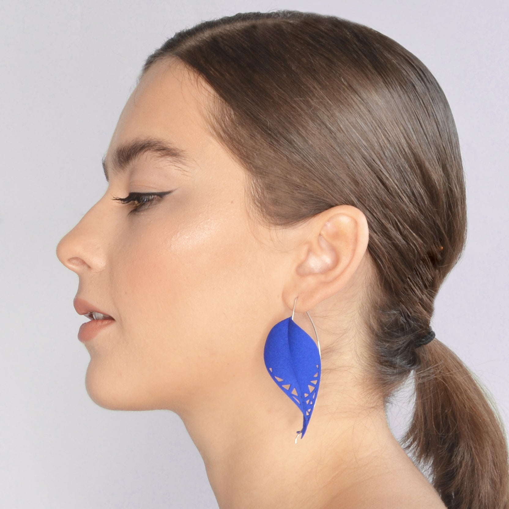 Oversize Leaf Earrings in vibrant colors inspired by rainforest flora, featuring a lightweight design and hypoallergenic materials.