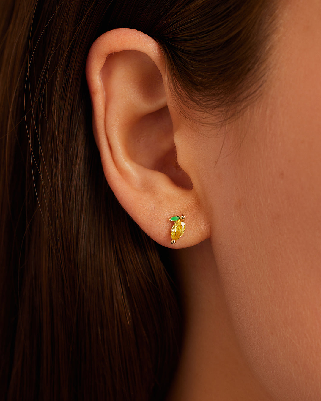 A pair of elegant Lemon Charm Stud earrings made of 14k gold, showcasing their delicate charm and stylish design.
