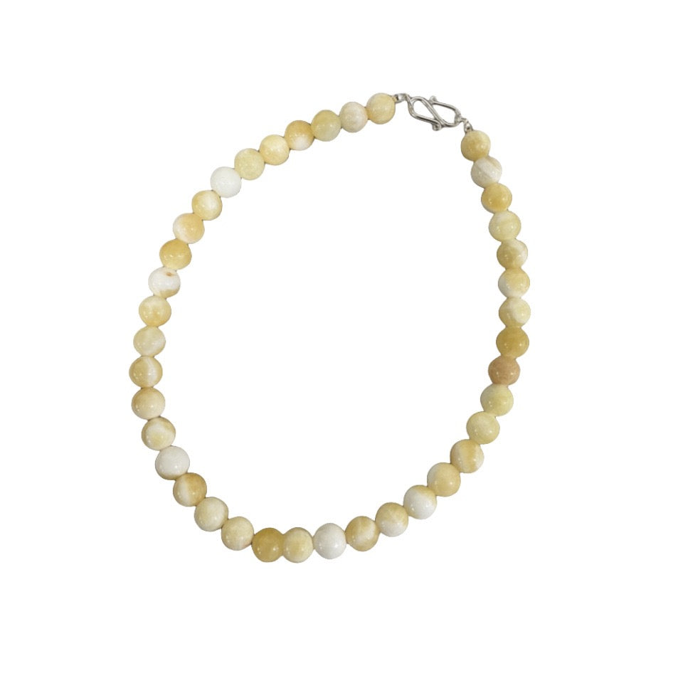 A vibrant Lemon Drop Delight Yellow Jade Necklace featuring naturally formed yellow jade stones resembling lemon candies, perfect for summer styling.
