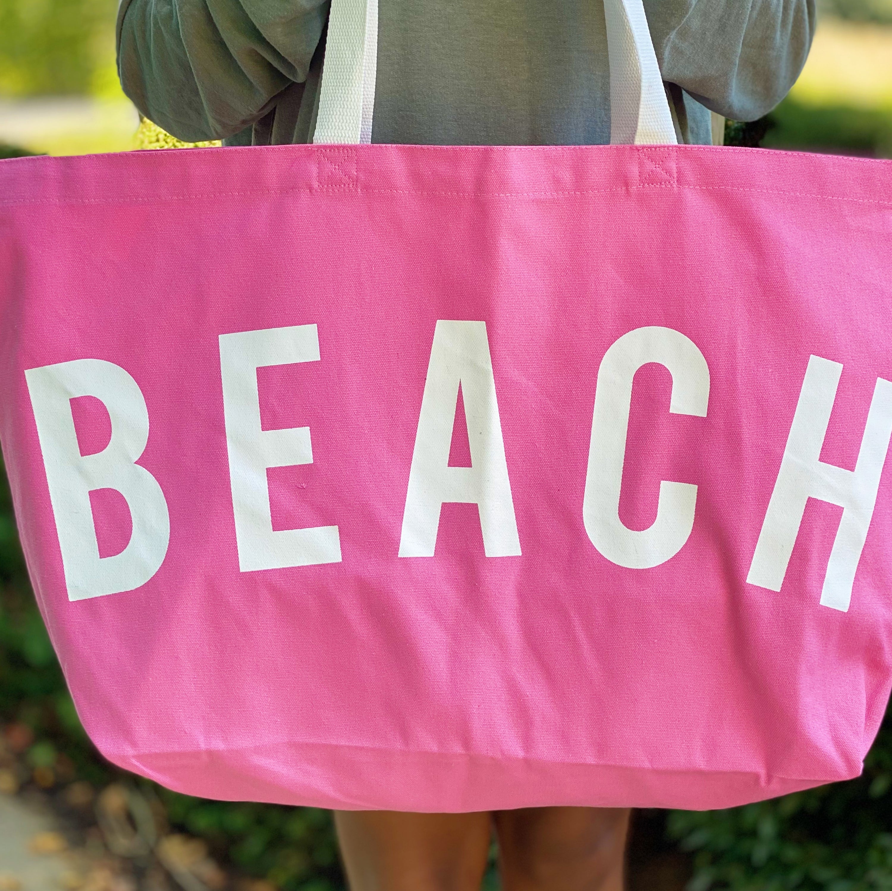 A spacious Let’s Do Beach Canvas Tote featuring the word 'BEACH' in stylish font, perfect for carrying essentials for beach outings and more.