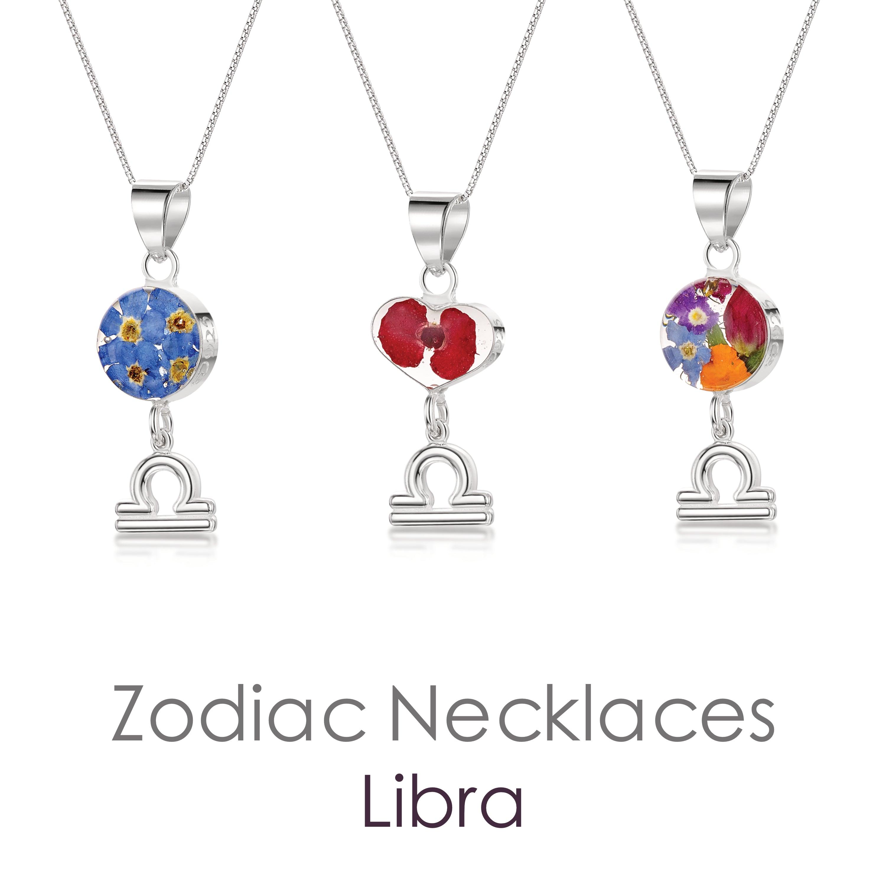 A beautiful Libra Necklace featuring a sterling silver pendant with real preserved flowers and a zodiac charm, showcasing elegance and individuality.