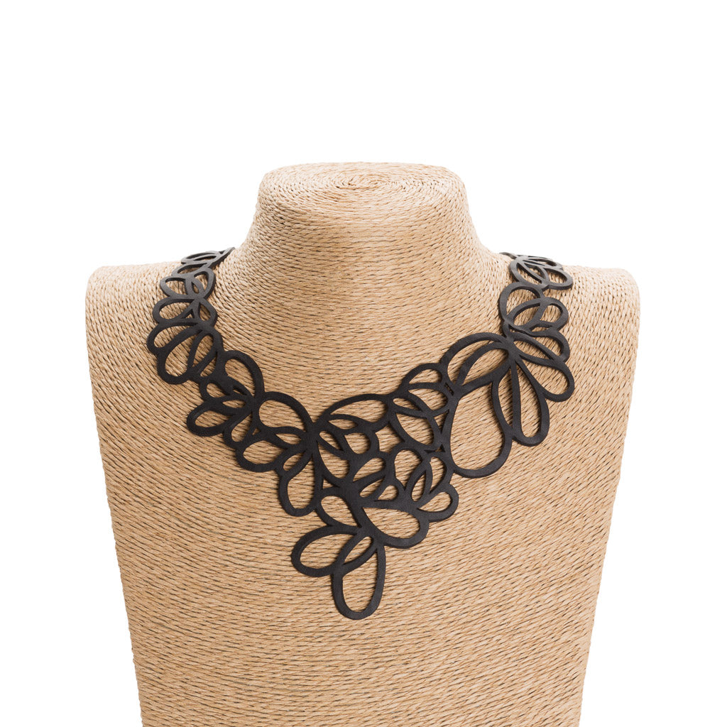 Lilac Statement Inner Tube Necklace handcrafted from reclaimed rubber, featuring an off-centre design and lightweight cord.