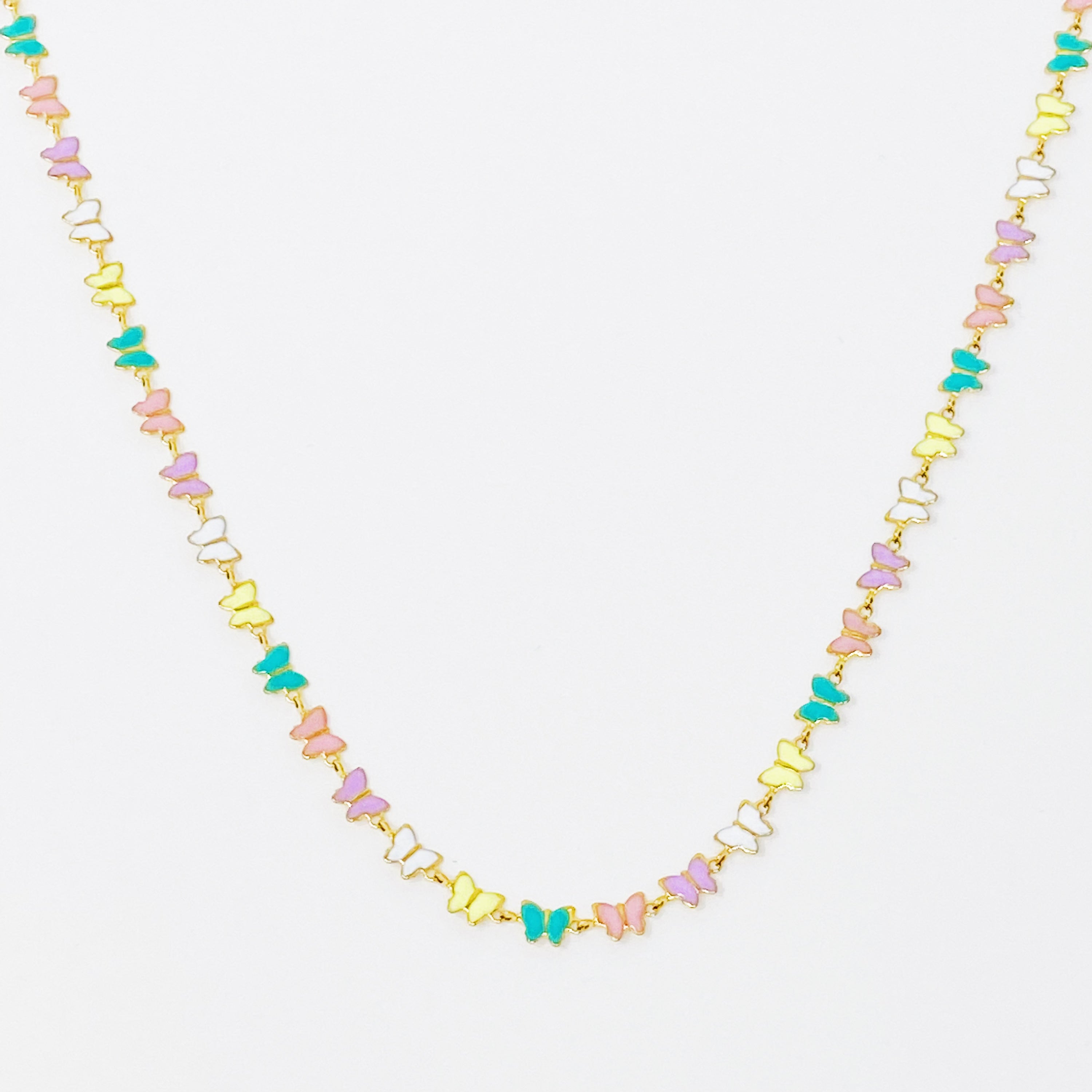 Linked Butterflies Necklace featuring pastel butterflies and a solid gold reversible side, crafted from gold plated stainless steel.