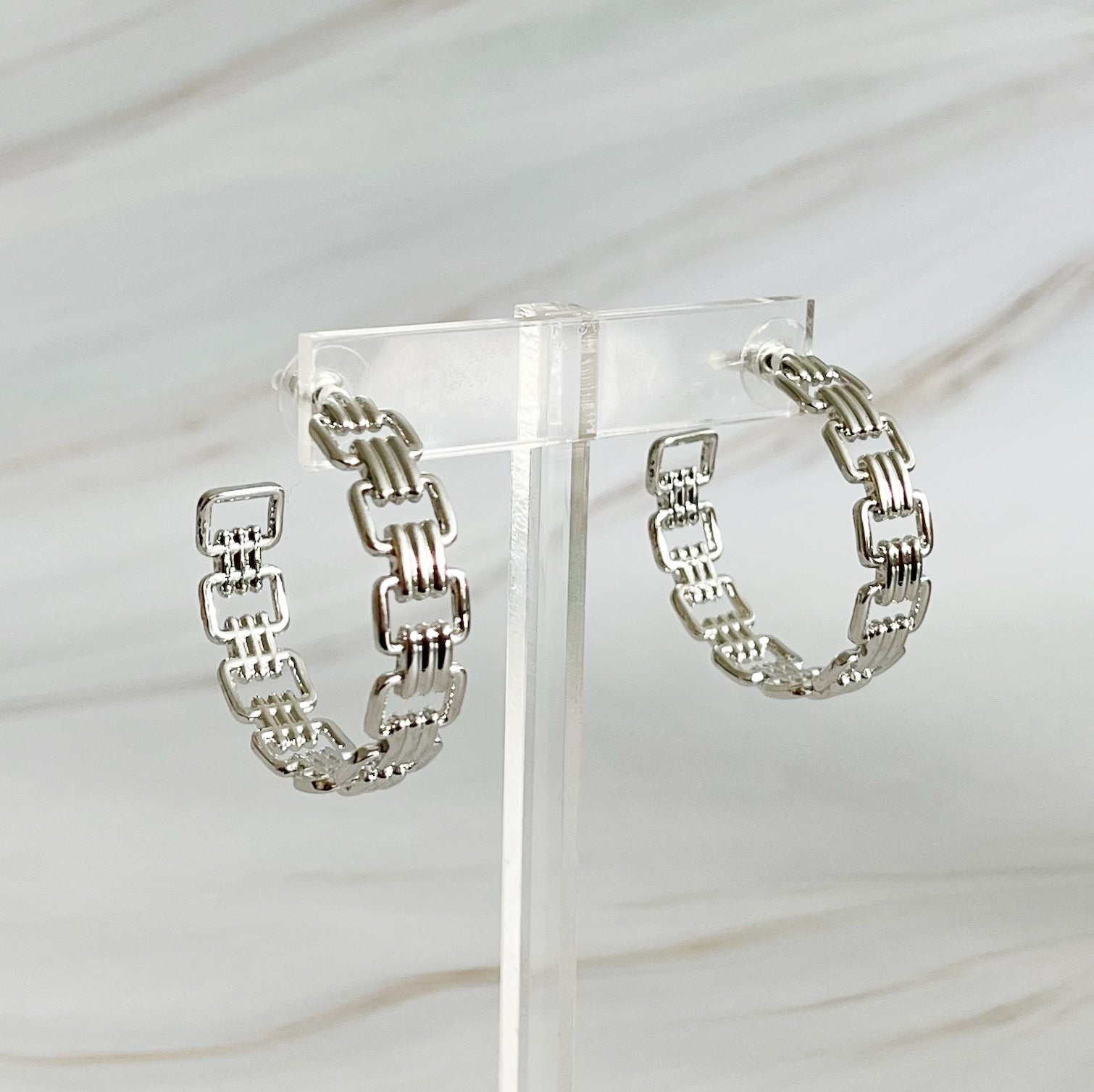 Elegant Linked Golden Hoop Earrings with a modern design, showcasing a unique linked pattern and a beautiful golden finish.