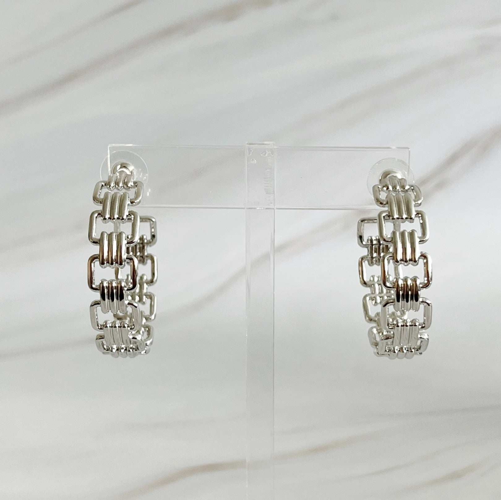 Elegant Linked Golden Hoop Earrings with a modern design, showcasing a unique linked pattern and a beautiful golden finish.