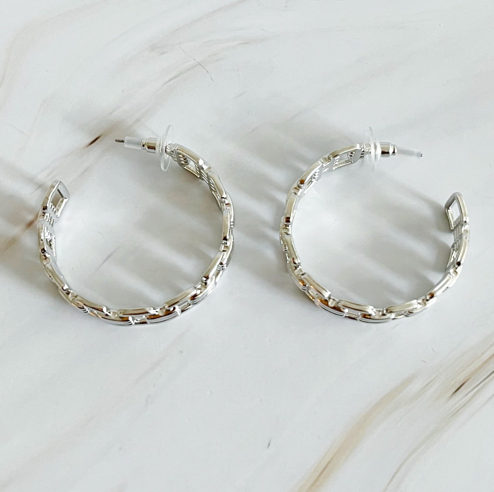 Elegant Linked Golden Hoop Earrings with a modern design, showcasing a unique linked pattern and a beautiful golden finish.