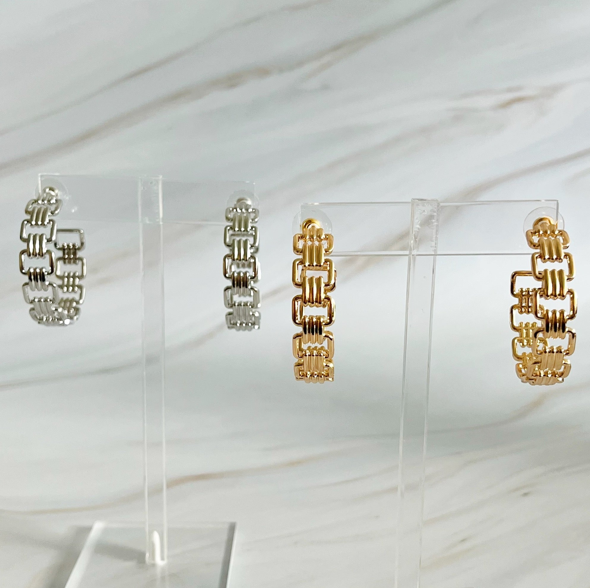 Elegant Linked Golden Hoop Earrings with a modern design, showcasing a unique linked pattern and a beautiful golden finish.