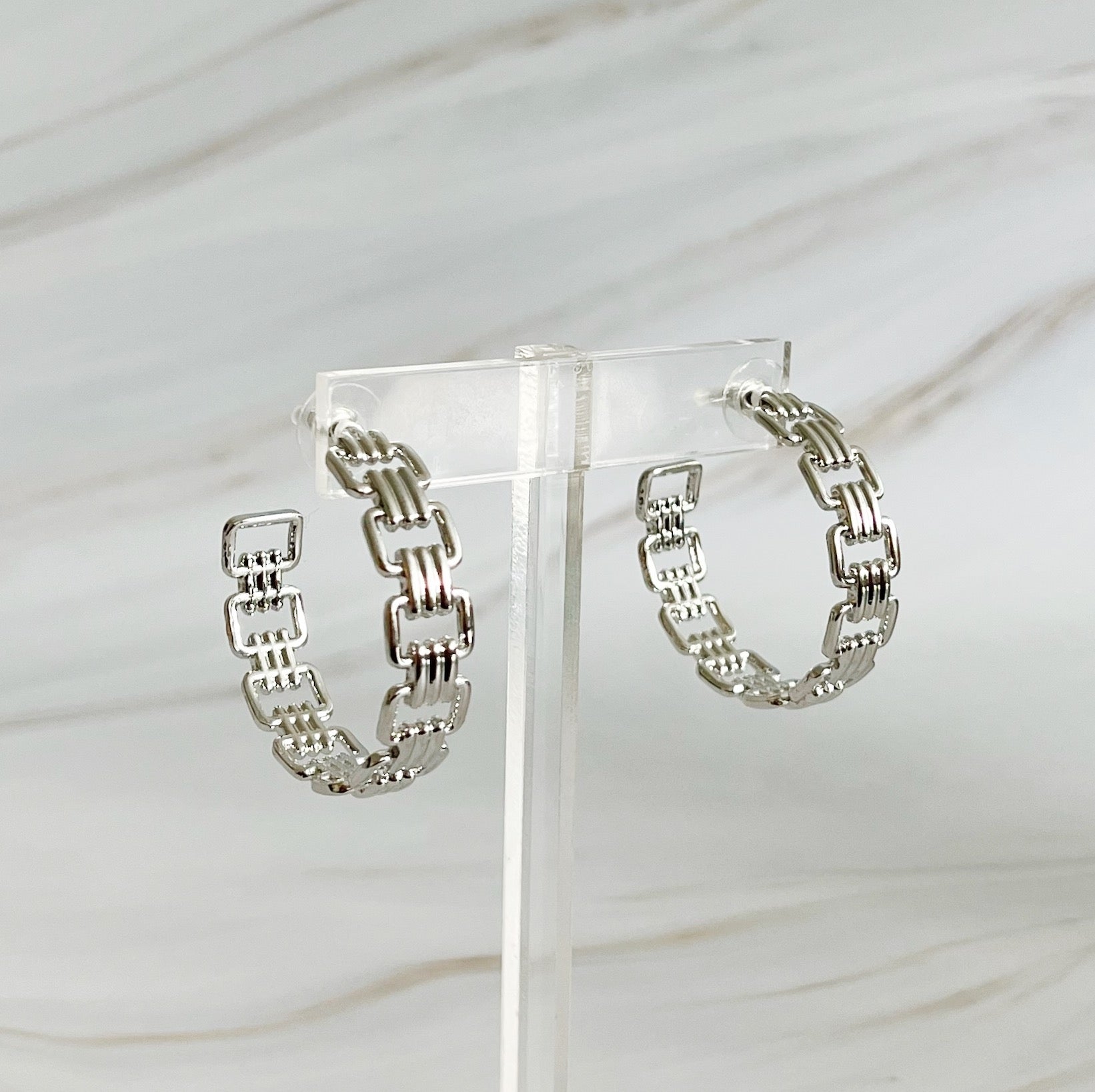 Elegant Linked Golden Hoop Earrings with a modern design, showcasing a unique linked pattern and a beautiful golden finish.