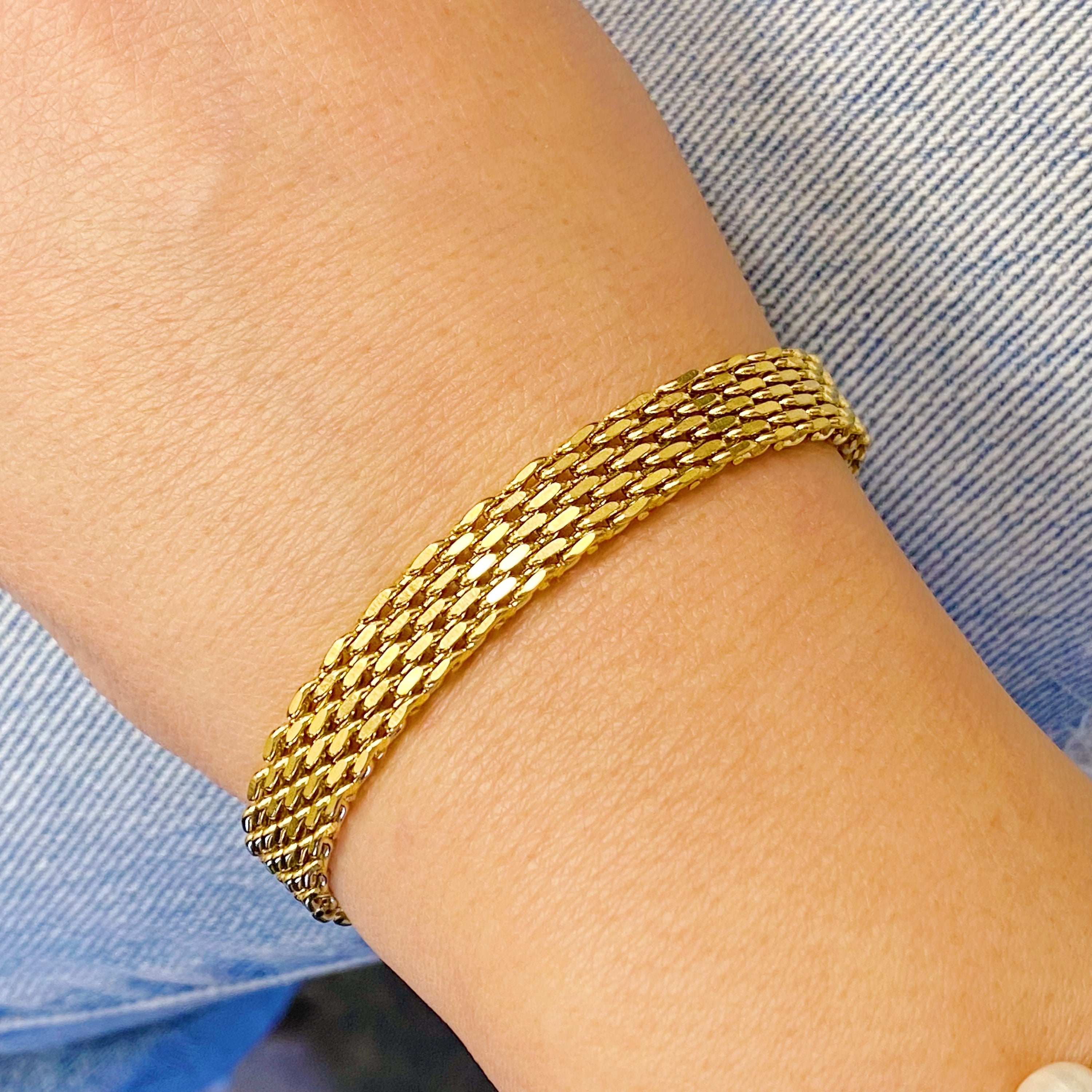 A stylish Links All Around Bracelet featuring a mesh gold design, adjustable length, and high-quality stainless steel construction.