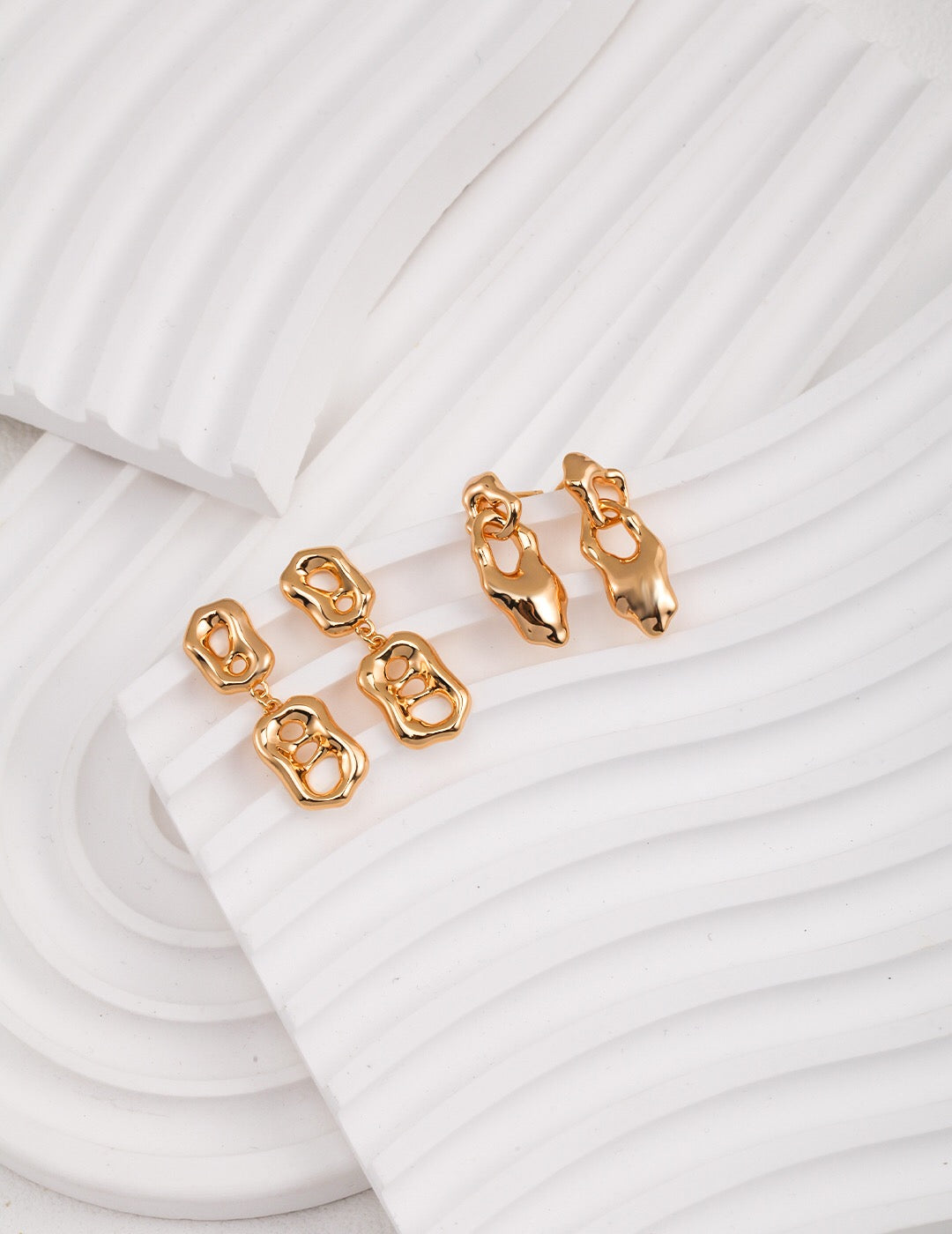 Elegant Liquid Flowing Shape Drop Earrings made of gold vermeil, showcasing a unique flowing design.