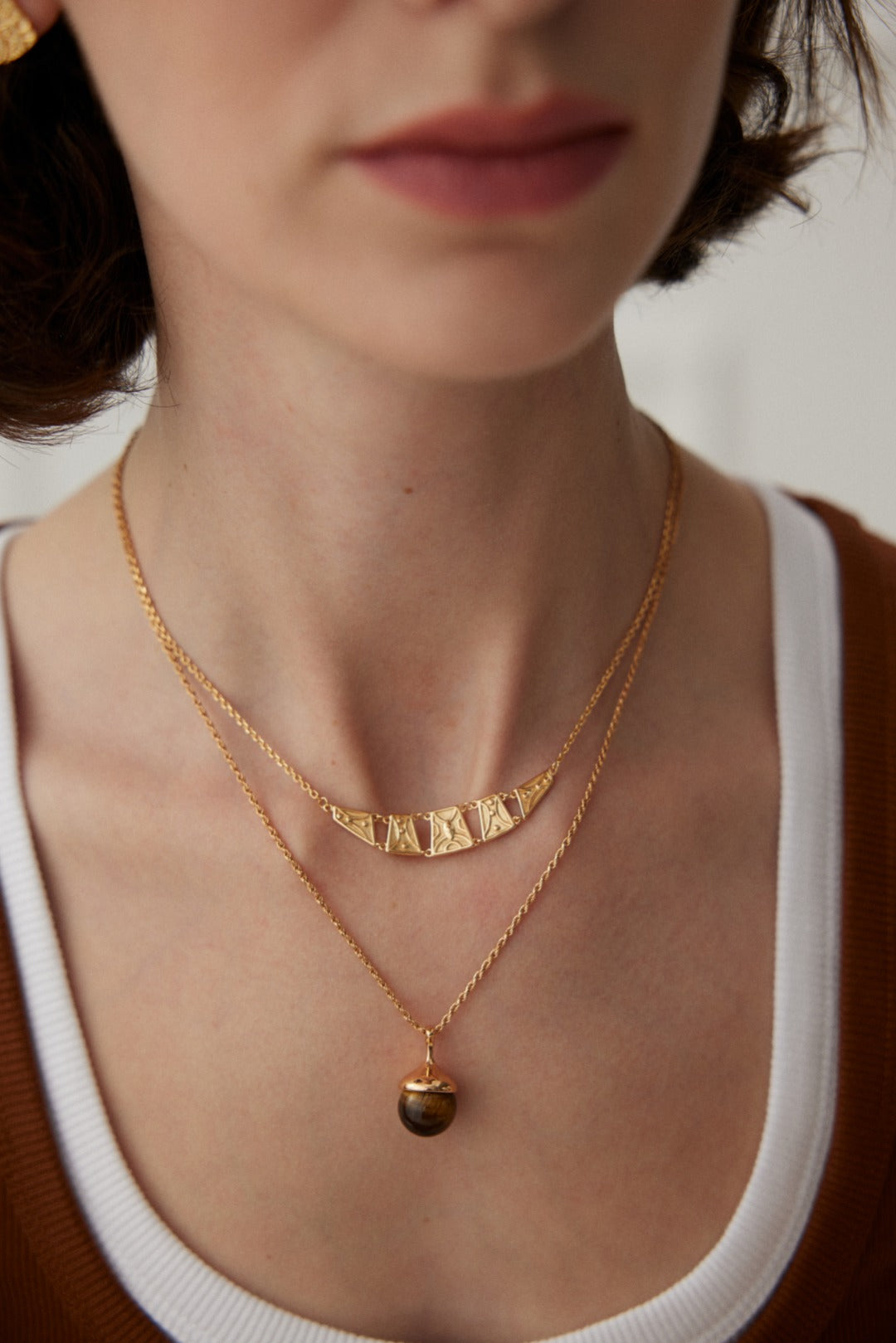 Little Hazelnut Pinecone Silver Necklace featuring tiger's eye stone and gray shell pearls, elegantly designed with a vintage gold chain.