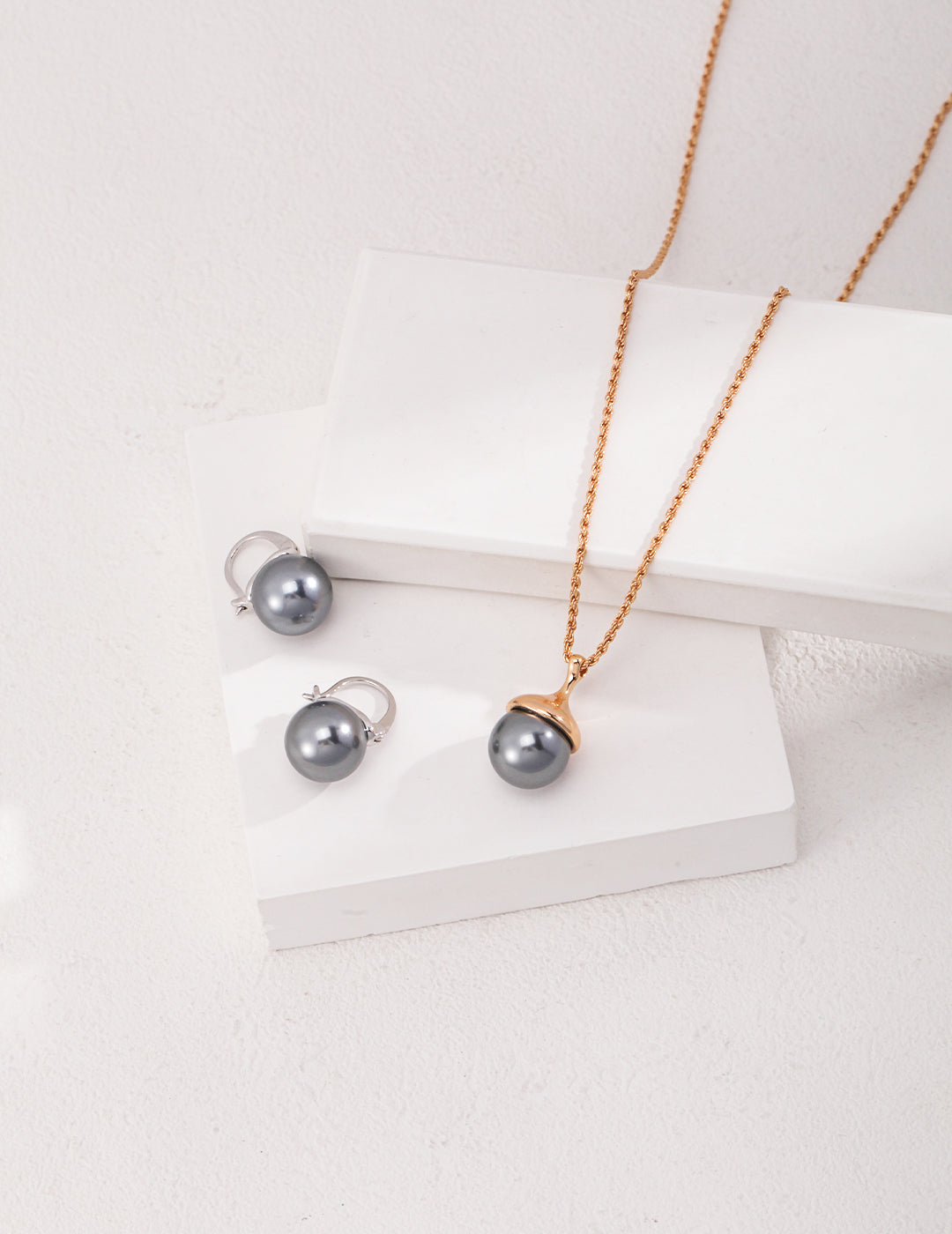 Little Hazelnut Pinecone Silver Necklace featuring tiger's eye stone and gray shell pearls, elegantly designed with a vintage gold chain.