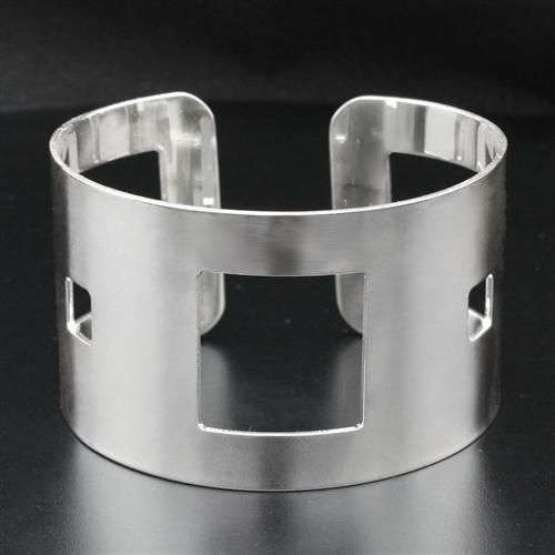 High polished stainless steel bangle with a sleek design, showcasing its shiny surface and lightweight structure.