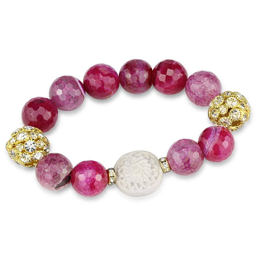 Gold brass bracelet featuring a vibrant fuchsia synthetic onyx stone, elegantly designed for stylish wear.