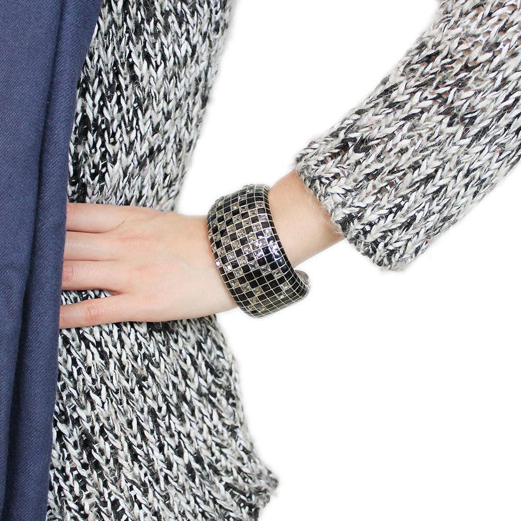 LO4272 Rhodium Brass Bangle featuring a stunning black diamond crystal centerpiece, elegantly designed for any occasion.