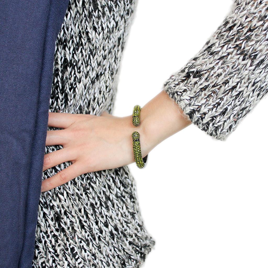 LO4284 TIN Cobalt Black Brass Bangle featuring a top grade olivine crystal centerpiece, showcasing elegance and modern design.