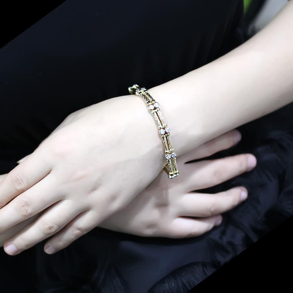 Gold and rhodium brass bracelet featuring a clear AAA grade cubic zirconia stone, elegantly designed for any occasion.