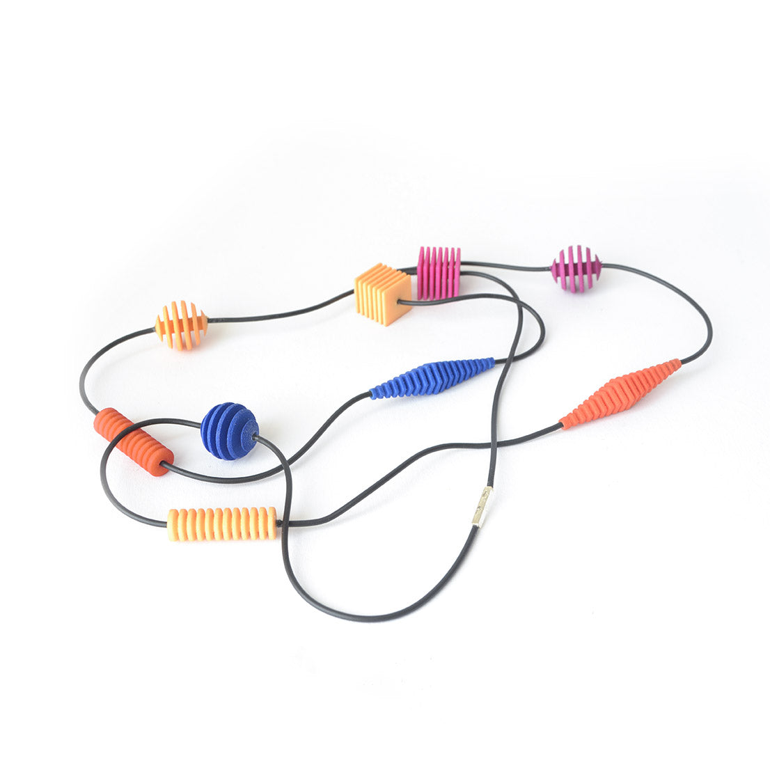 Long Beaded Optical Necklace featuring vibrant hand-dyed beads in geometric shapes, perfect for stylish outfits.