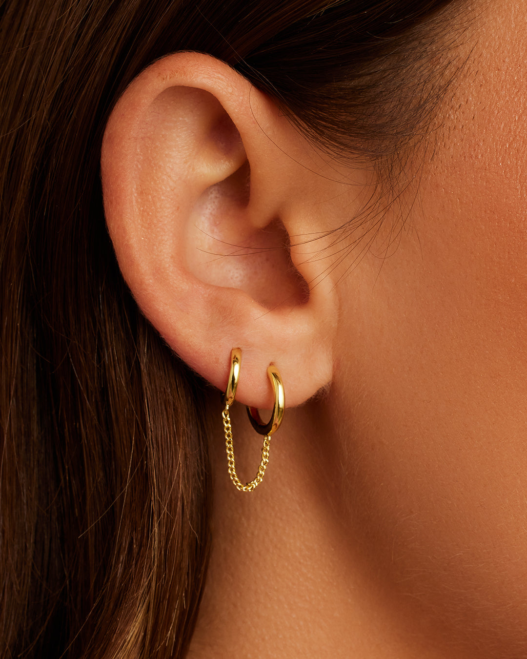 Lou Double Huggie earrings featuring a sleek double huggie design, crafted from high-quality materials for durability and style.