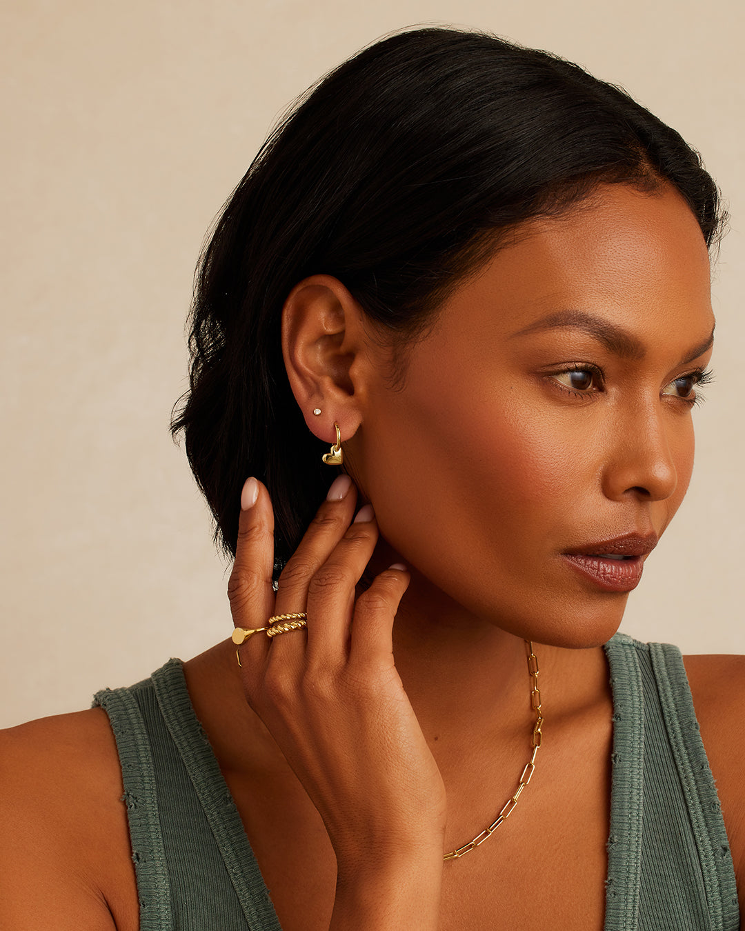 Lou Heart Huggies earrings featuring a charming heart-shaped design, lightweight and stylish for everyday wear.