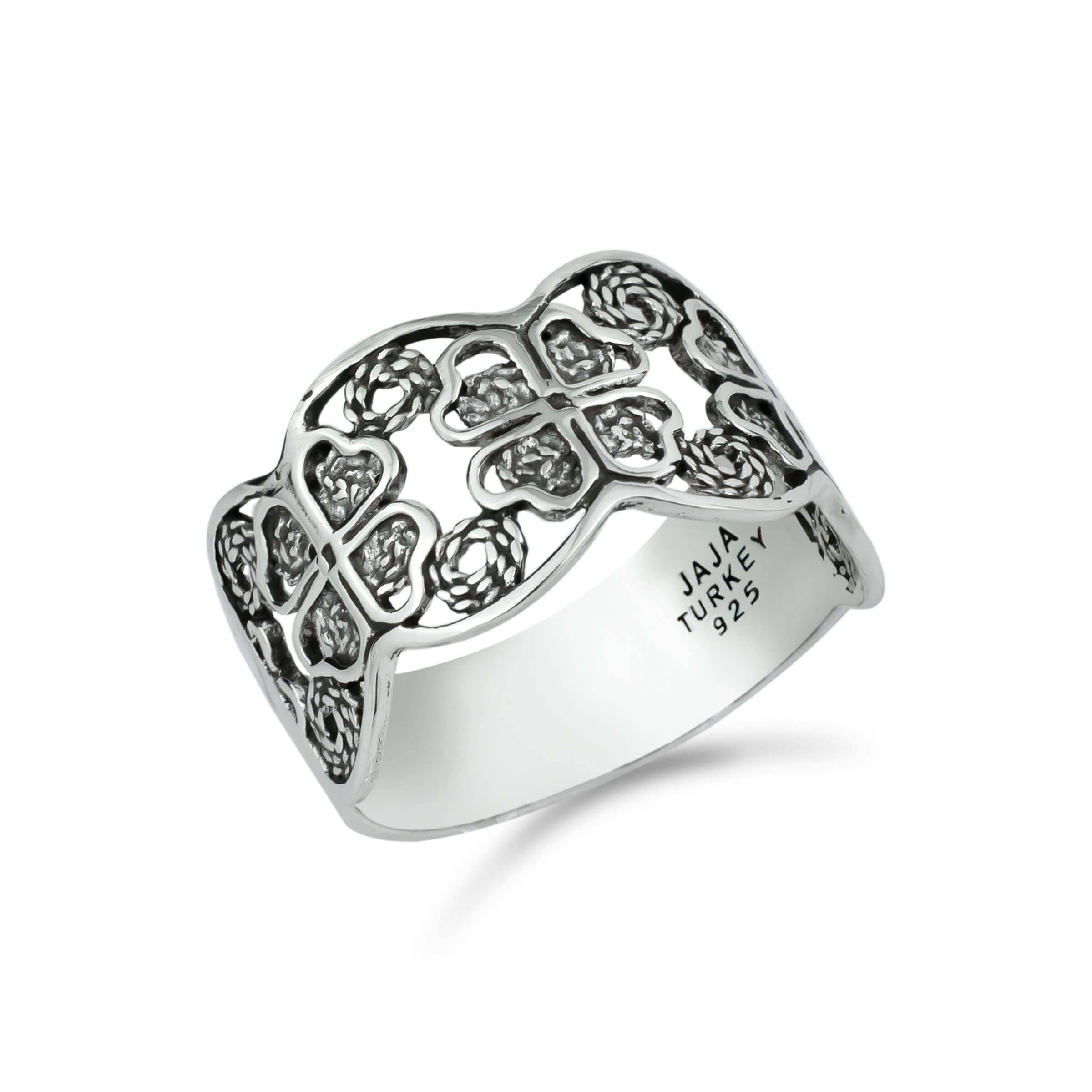 A stunning 925 sterling silver filigree art band ring featuring a four clover design, showcasing intricate metalwork and a polished finish.
