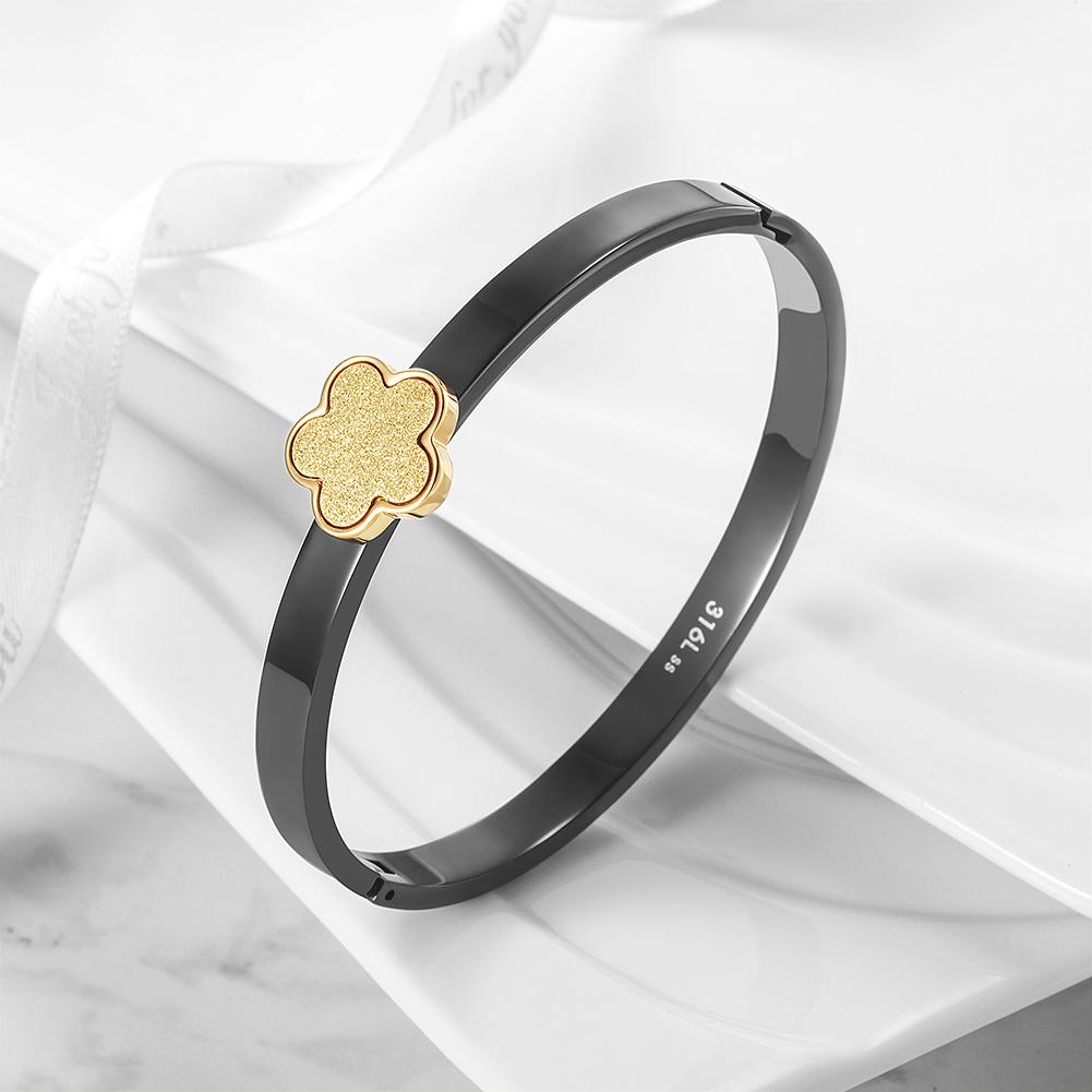 A stylish LUCKY CLOVER BANGLE made of 316L surgical stainless steel with 14K gold PVD plating, showcasing a clover design.